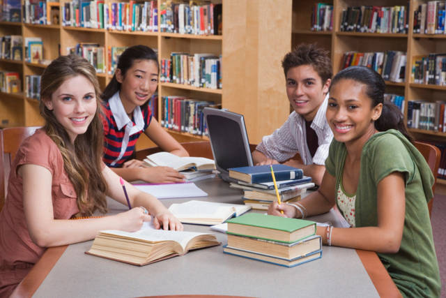 Teenagers studying in library